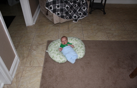 Toren in the boppy pillow with size references