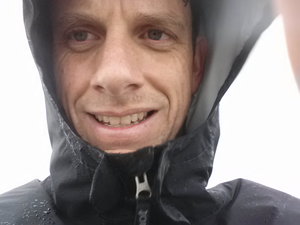Me on the summit in the blustery wind and light, misty rain.