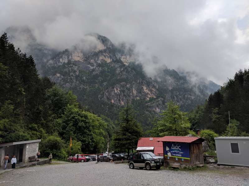 A view of the restaurant in Prionia from the trailhead showing the rugged mountains in the background.